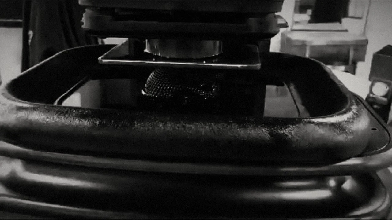 A printed part emerging from resin during the Gomicron printing process