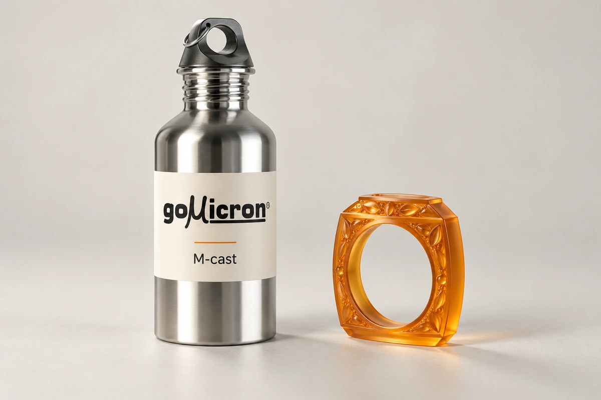 M-cast resin bottle beside a smooth amber casting-pattern sample